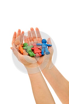 Hands holding colorful clay people