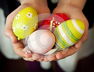 Hands Holding Colorful Easter Eggs