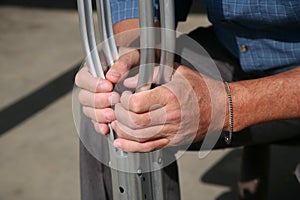 Hands holding crutches photo