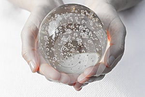 Hands holding a crystal ball