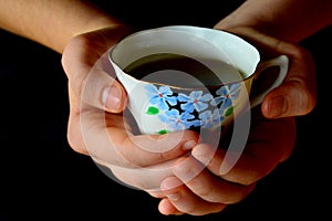 Hands Holding Cup of Tea