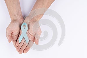 Hands holding cyan ribbon. White background