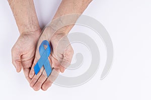 Hands holding dark blue ribbon. White background