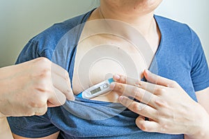 Hands holding a digital thermometer