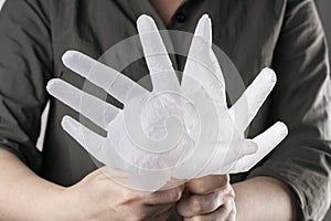 Hands holding disposable vinyl gloves filled with air. New normal reality. Infection prevention during lockdown