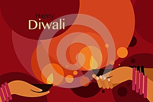 Hands holding Diwali oil lamps