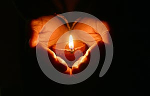 Hands holding diya