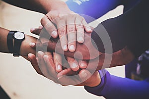 Diverse group of people holding hands in supportive gesture photo