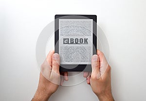 Hands holding an ebook with text on white  table