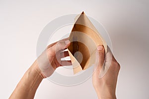 Hands holding envelope with coins money on white background