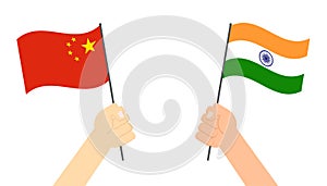 Hands holding flag between China and India face to face for competition