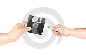 Hands Holding Floppy Disk Versus Flash Memory Stick