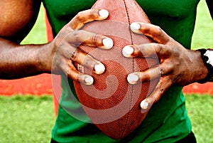 Hands holding football