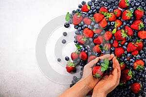 Hands holding fresh berries. Healthy clean eating, dieting, vegetarian food, detox concept. Close up of woman hands over
