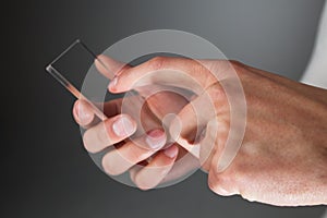 Hands holding futuristic transparent phone