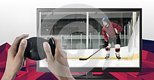 Hands holding gaming controller with ice hockey player on television
