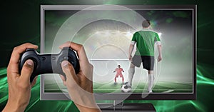 Hands holding gaming controller with soccer player on television