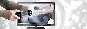 Hands holding gaming controller with table tennis on television