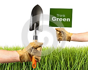 Hands holding garden trowel and sign photo