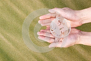 Hands Holding Glass Globe
