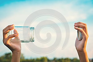 Hands holding glass jar for keeping fresh air