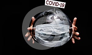 Hands holding globe sphere where shown white board COVID-19