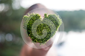 Hands holding green heart shaped tree love nature save the world heal the world environmental preservation