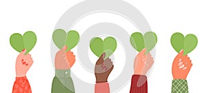 Hands holding green hearts