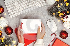 Hands holding greeting card mockup Red and white Christmas baubles banner