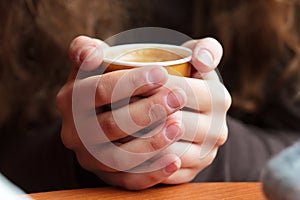 Hands holding hot coffee