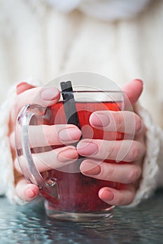 Hands holding hot cup of coffee or tea