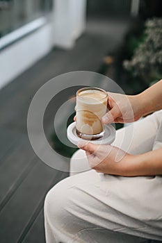 Hands holding hot cup of coffee or tea Close-up on background of a living room  with natural,