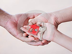 hands holding a house key