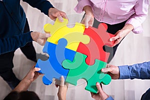 Hands Holding Jigsaw Puzzle