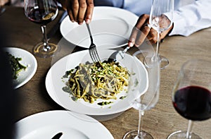 Hands Holding Knife and Fork Getting Food From Dish