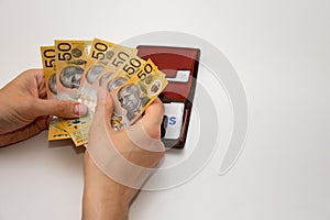 Hands holding leather wallet with australian dollars 50 banknotes. Finance concept with copy space