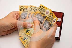 Hands holding leather wallet with australian dollars 50 banknotes. Finance and payment concept