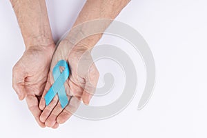 Hands holding light blue ribbon. White background