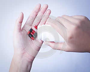 hands holding medicine capsule