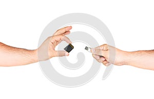 Hands Holding Memory Card Versus Flash Memory Stick