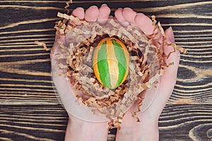 Hands holding modern painted easter egg