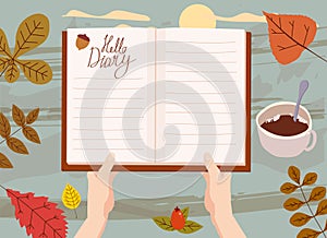 Hands holding an open Autumn Daily Diary notepad, list schedule, goals, to do, acorn, autumn leaves, coffe cup. Personal