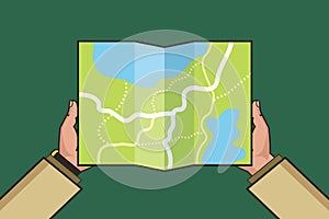 Hands holding paper map. Folded map in hands of men. Tourist look at map. Vector Illustration in flat design. Travel