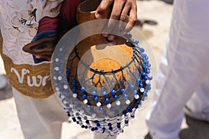 Hands holding percussion instrument