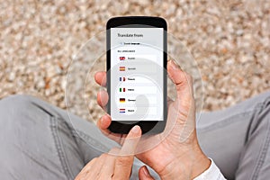 Hands holding phone with language translator app concept on screen