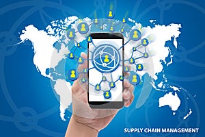 Hands holding the phone Supply Chain Management concept on blue