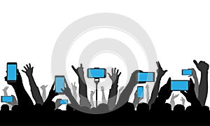 Hands holding phones, smartphones on background of raised human hands. Silhouette of cheerful crowd of people at concert or sport