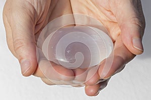 Hands holding piece of Selenite