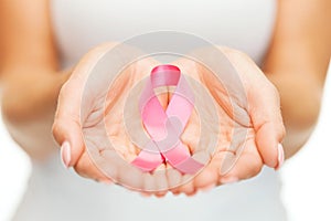 Hands holding pink breast cancer awareness ribbon