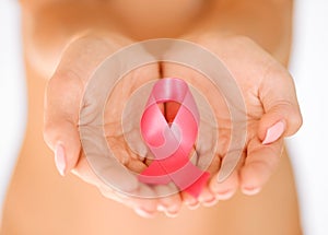 Hands holding pink breast cancer awareness ribbon